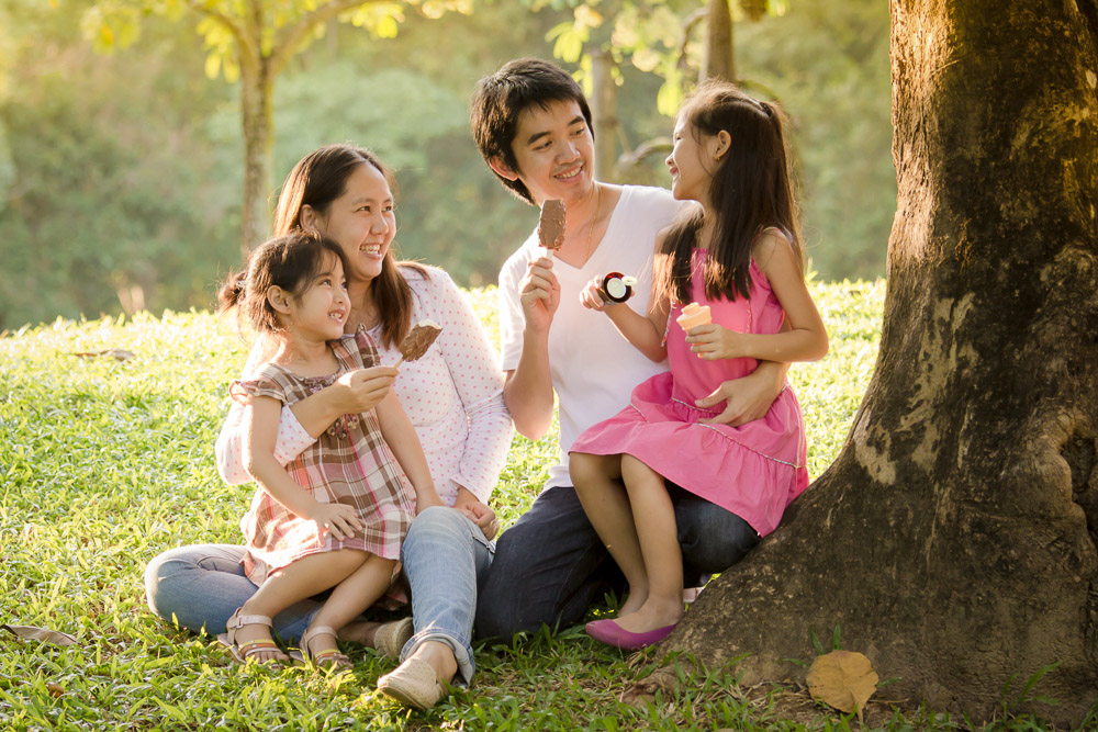 Asian family with icecream in park