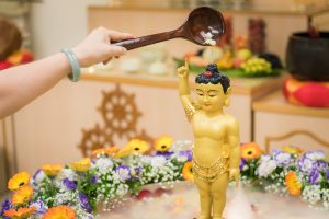 Close up of bathing the buddha on Vesak Day